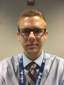 Aria Davenport with glasses and tie.